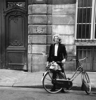 Polly Platt with her bicycle at her home  in Paris